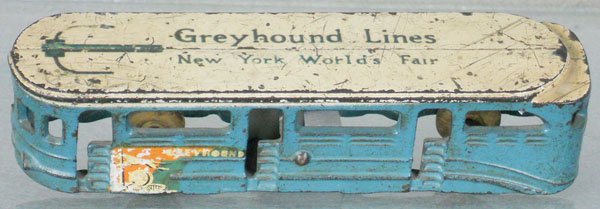 ARCADE NY WORLD'S FAIR GREYHOUND BUS: painted cast iron, 7" long, decals have minor wear, rubber tires worn, C5.