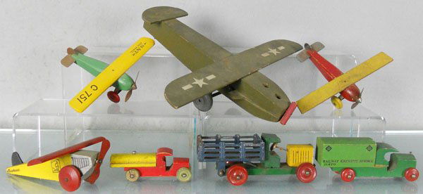7 WOODEN TOYS: 4 Airplanes, 4 1/2" to 12" wingspans, Army Plane missing bombs & propeller blades, 3 Trucks, 4" to 6" long, C5.