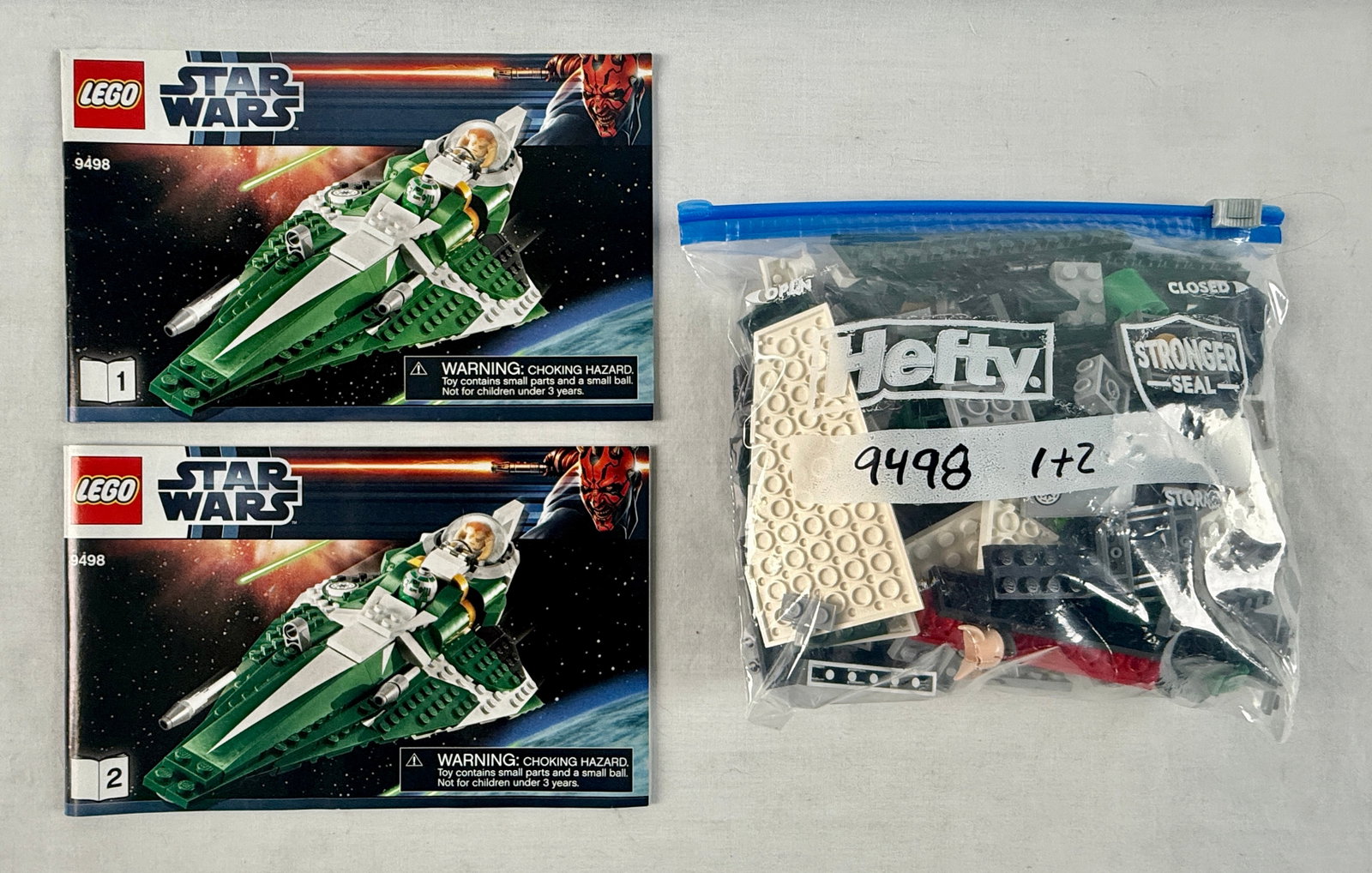LEGO Star Wars Saesee Tiin's Jedi Starfighter Set 9498: This LEGO Star Wars construction set is identified as set number 9498, Saesee Tiin's Jedi Starfighter. Included in this lot are two original instruction manuals and a collection of loose building comp