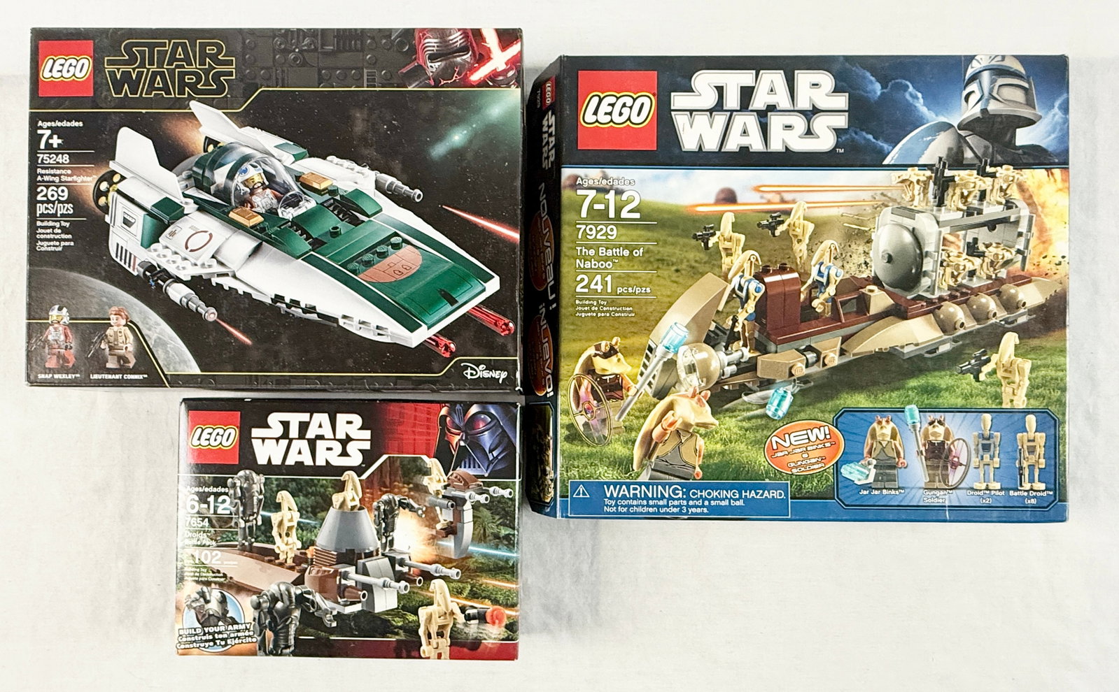 A Trio of LEGO Star Wars Building Sets: 75248, 7929, and 7654: This lot features three LEGO Star Wars building sets: set 75248 Resistance A-Wing Starfighter, set 7929 The Battle of Naboo, and set 7654 Droids Battle Pack. Set 75248 Resistance A-Wing Starfighter