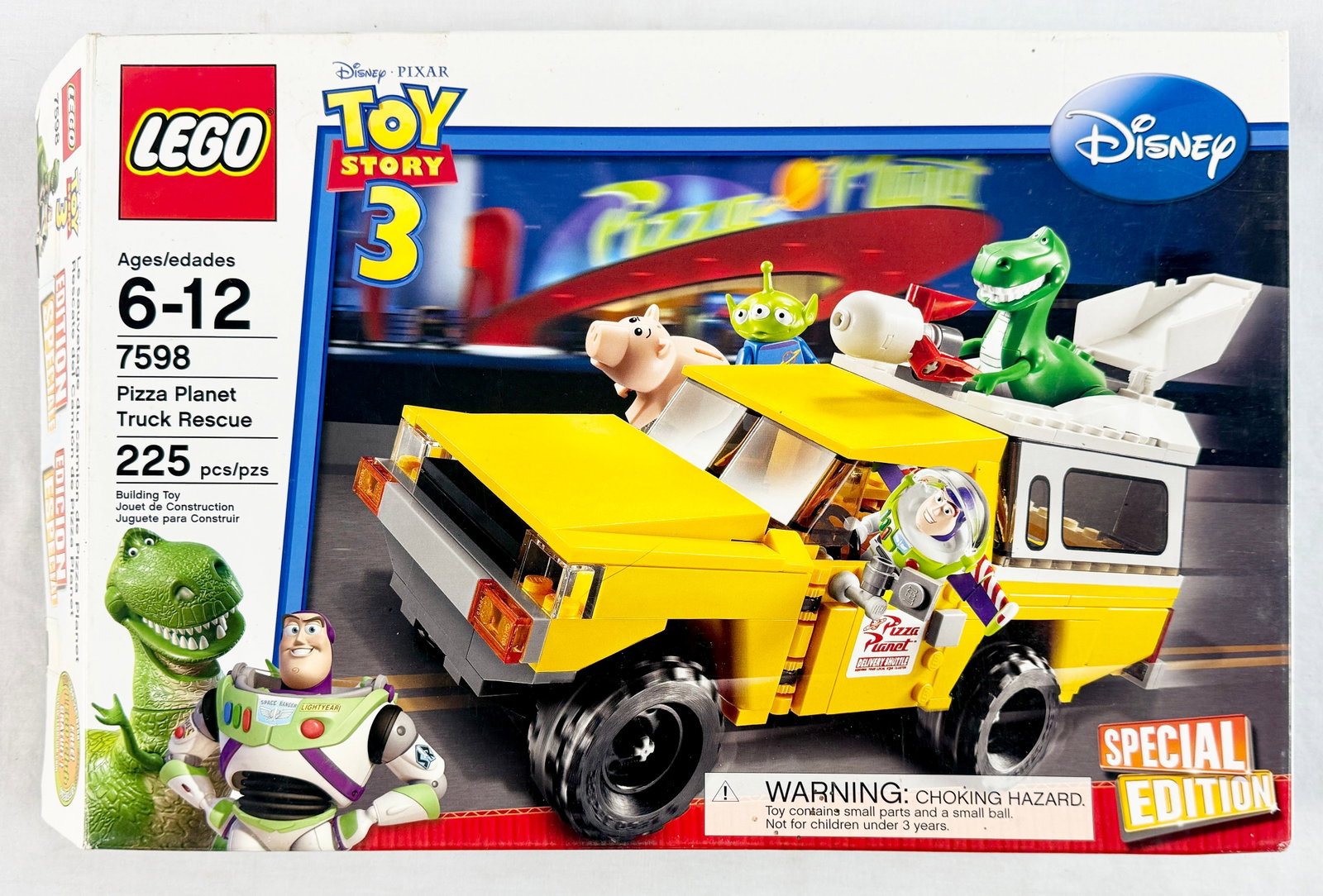 LEGO Toy Story 3 Pizza Planet Truck Rescue Set 7598: This LEGO building set is themed from the Disney/Pixar film Toy Story 3 and is identified as set number 7598, titled Pizza Planet Truck Rescue. The set features a yellow delivery truck with a white ca