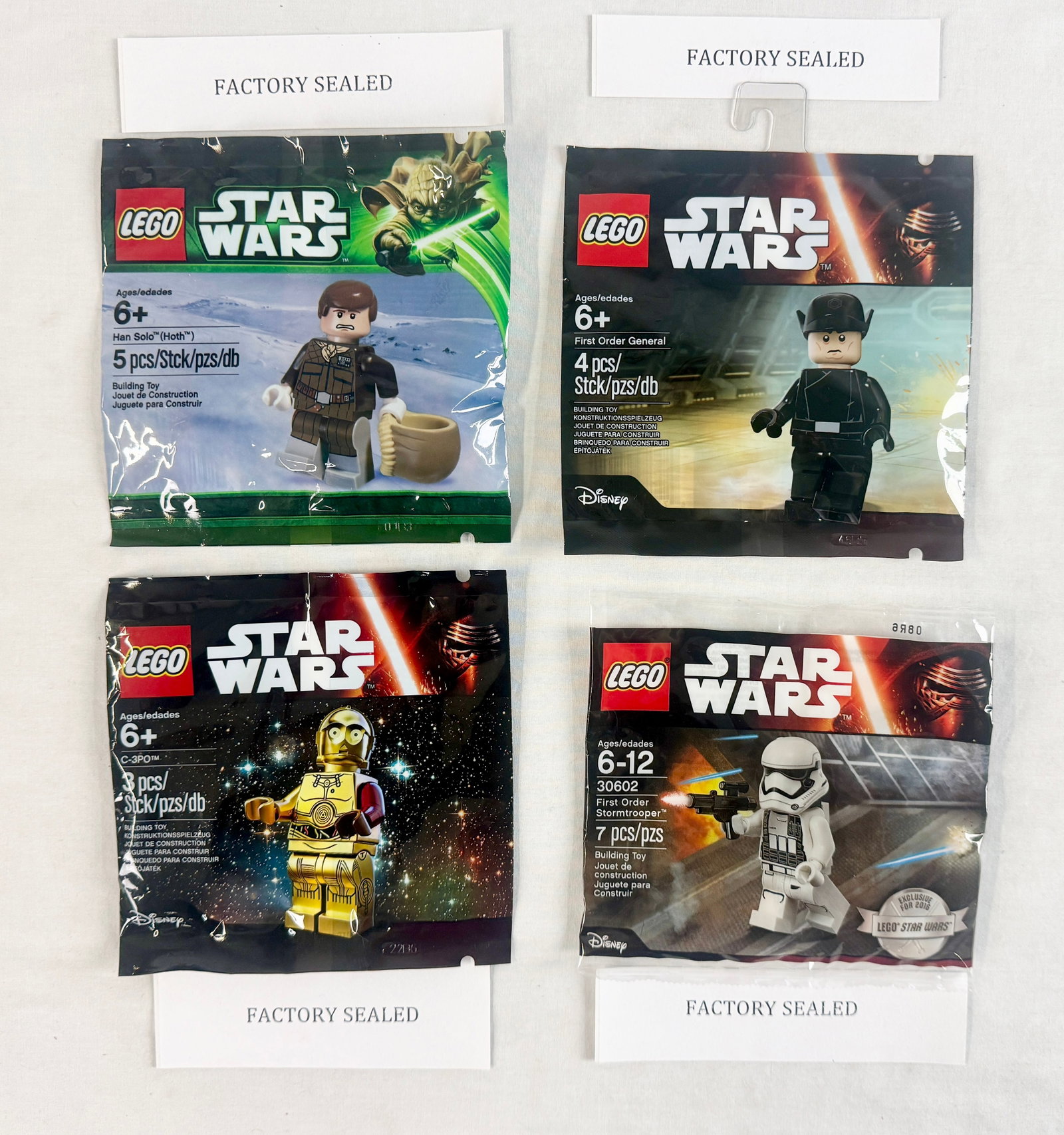 A Collection of Four LEGO Star Wars Promotional Minifigure Polybags: A collection of four LEGO Star Wars promotional minifigure sets, each housed in its original factory-sealed plastic polybag. These sets were typically distributed as gift-with-purchase items or throug