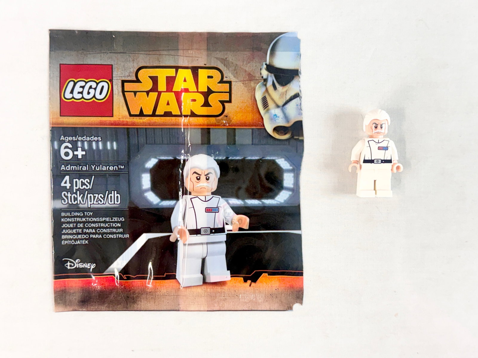 LEGO Star Wars Admiral Yularen Minifigure Polybag Set 5002947: A LEGO Star Wars Admiral Yularen minifigure, set number 5002947. This promotional item was released in 2015. The figure is constructed from four components: a light bluish gray hairpiece, a head with 
