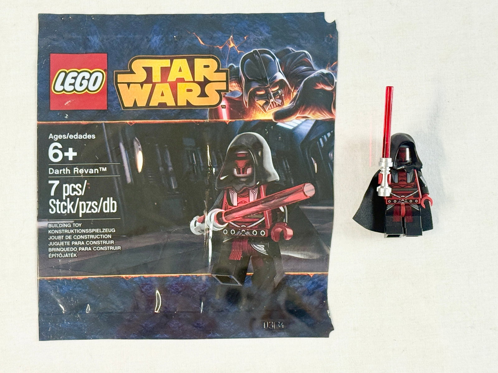 LEGO Star Wars Darth Revan Minifigure with Original Polybag 5002123: This lot features a LEGO Star Wars Darth Revan minifigure, identified as promotional set 5002123 from 2014. The minifigure is composed of a head with a custom printed mask, a hood piece, a torso with 