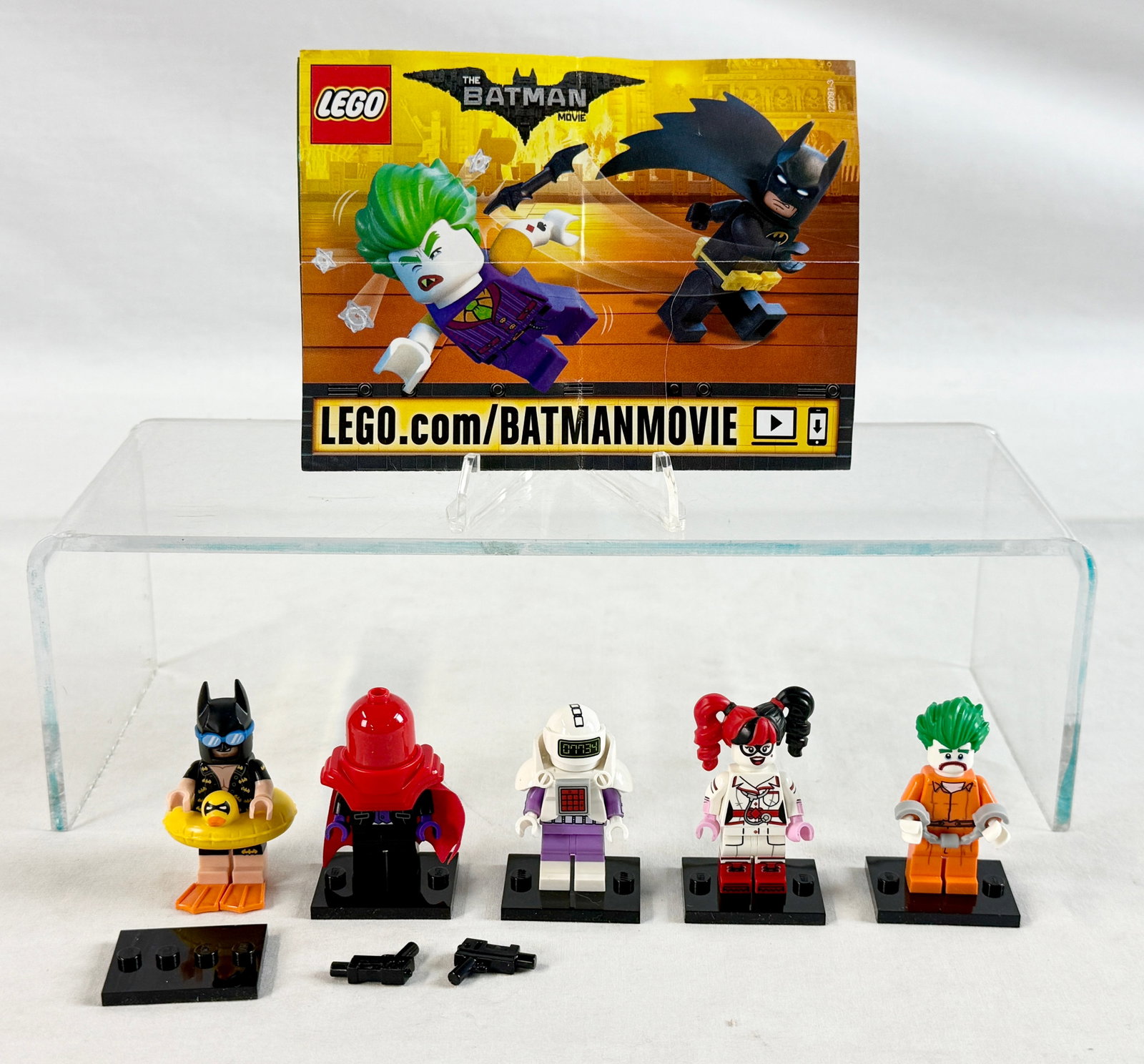 A Collection of Five LEGO Batman Movie Series 1 Collectible Minifigures: This collection consists of five loose minifigures from The LEGO Batman Movie Series 1, Set 71017, manufactured by The LEGO Group in 2017. The group includes the following characters: Vacation Batman,