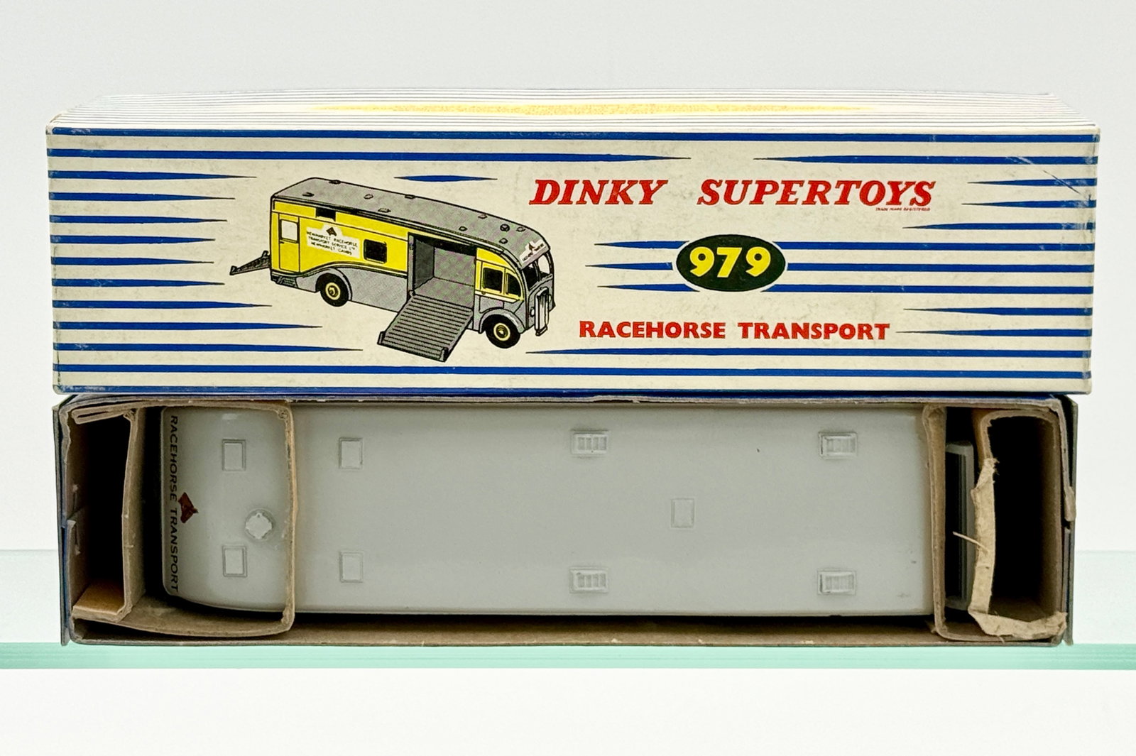 Dinky Supertoys No. 979 Newmarket Racehorse Transport with Original Box: This Dinky Supertoys No. 979 Newmarket Racehorse Transport die-cast model is finished in a two-tone yellow and gray livery with yellow hubs. The vehicle features Newmarket Racehorse Transport Service 