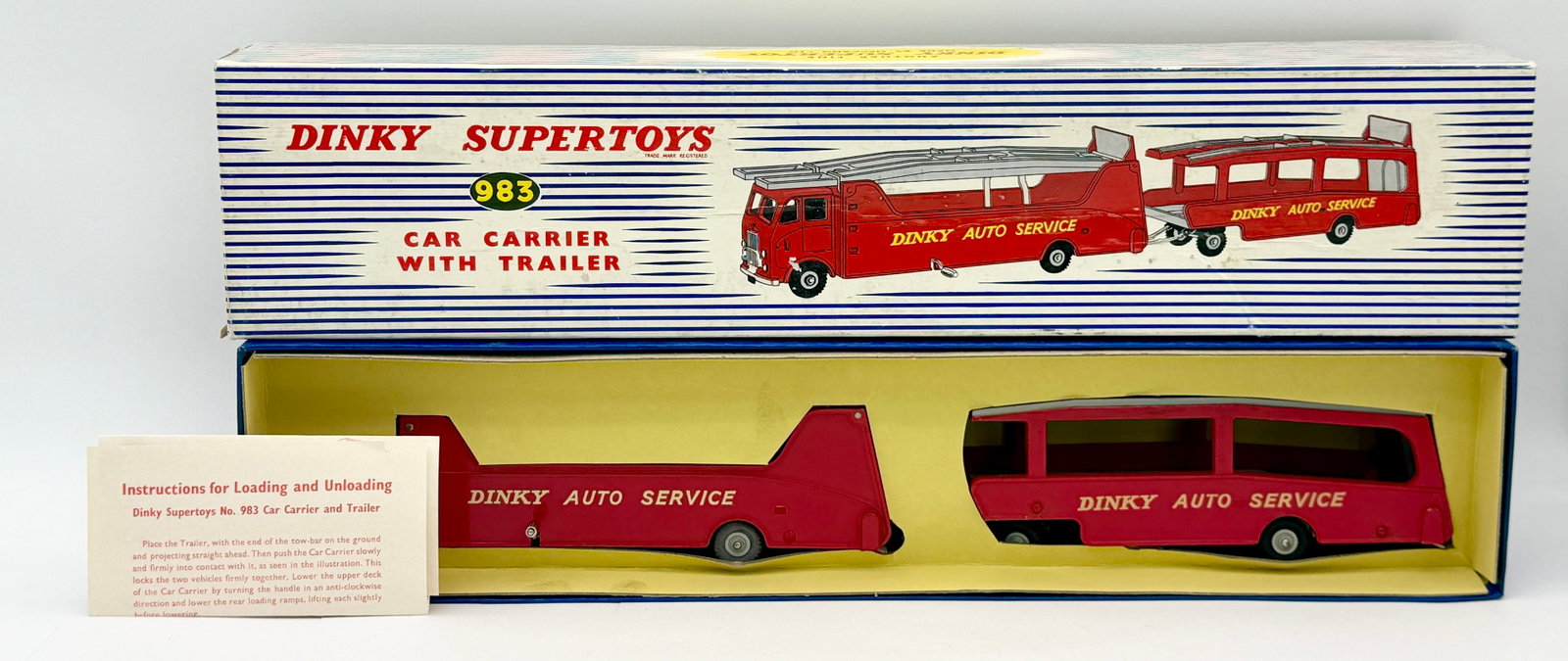 Dinky Supertoys No. 983 Car Carrier with Trailer Boxed: This Dinky Supertoys No. 983 Car Carrier with Trailer features a die-cast metal construction finished in red with Dinky Auto Service livery and grey ramps. The set includes the articulated prime mover