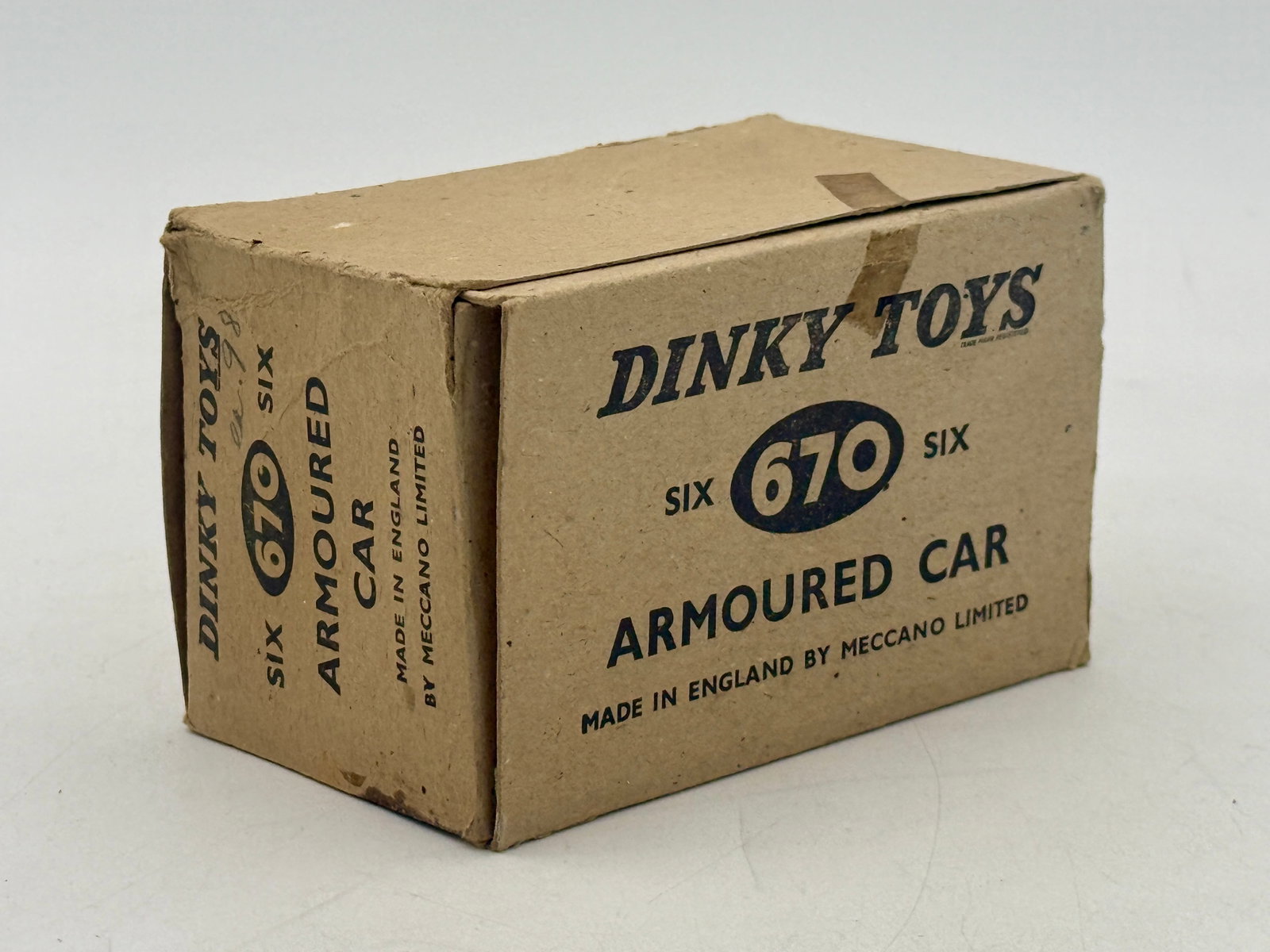 5 Dinky Toys No. 670 Armored Cars in Trade box: This collection of Dinky Toys No. 670 Armored Cars was manufactured in England by Meccano Limited. Each die-cast military vehicle is finished in matte green and features a rotating turret and black wh
