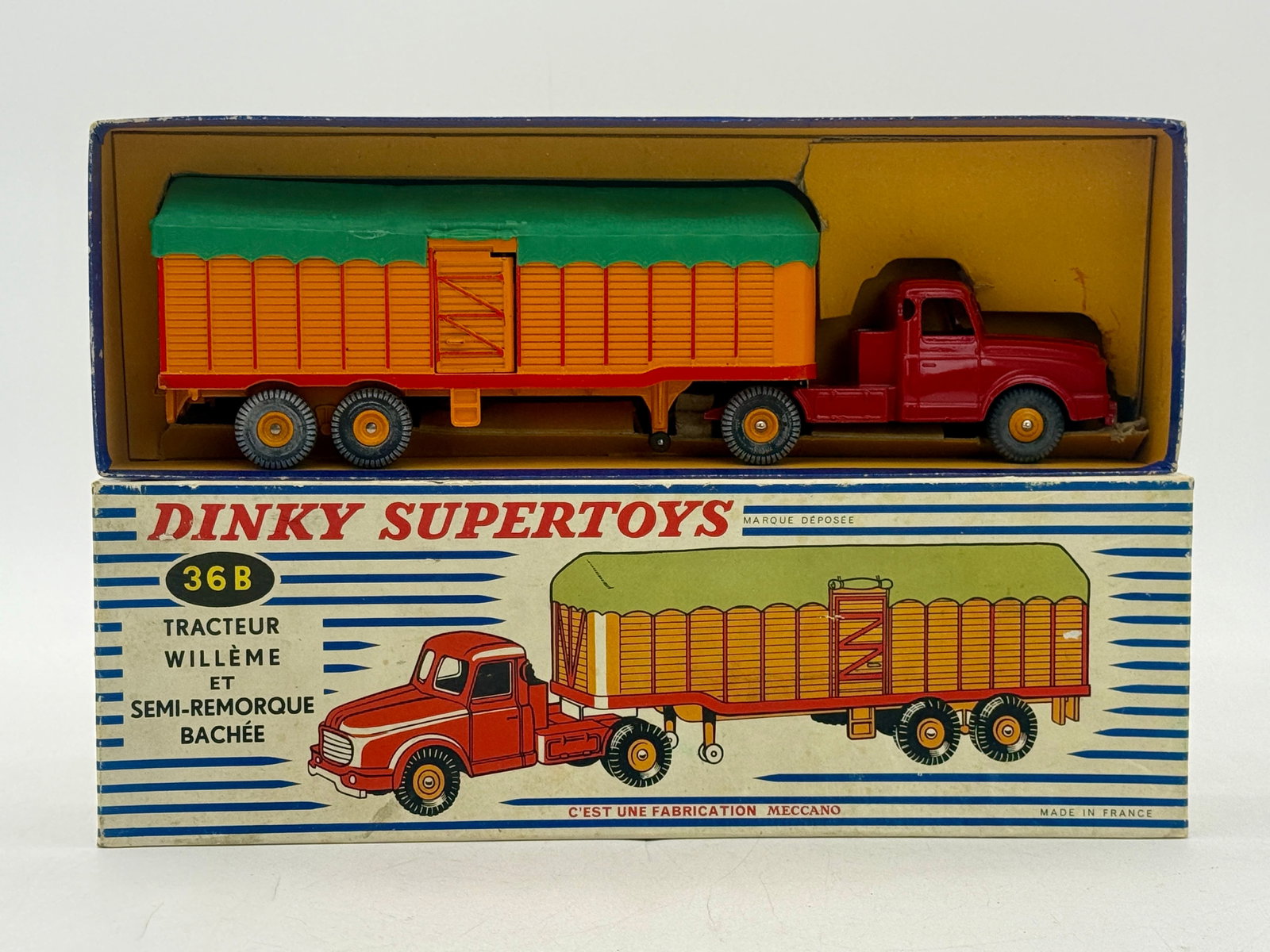 French Dinky Supertoys No. 36B Willeme Tractor and Semi-Trailer: French Dinky Supertoys No. 36B Willeme Tractor and Semi-Trailer manufactured by Meccano. The die-cast vehicle set features a red tractor unit and an orange trailer with a removable green plastic tilt 