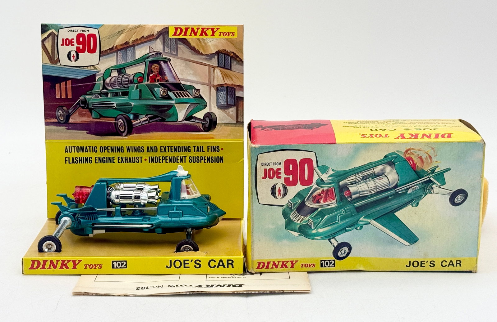 Dinky Toys 102 Joe 90 Joe's Car with Original Packaging: Dinky Toys No. 102 "Joe's Car" from the Gerry Anderson television series Joe 90. This die-cast model features a metallic teal finish with silver-tone engine components and functional feature