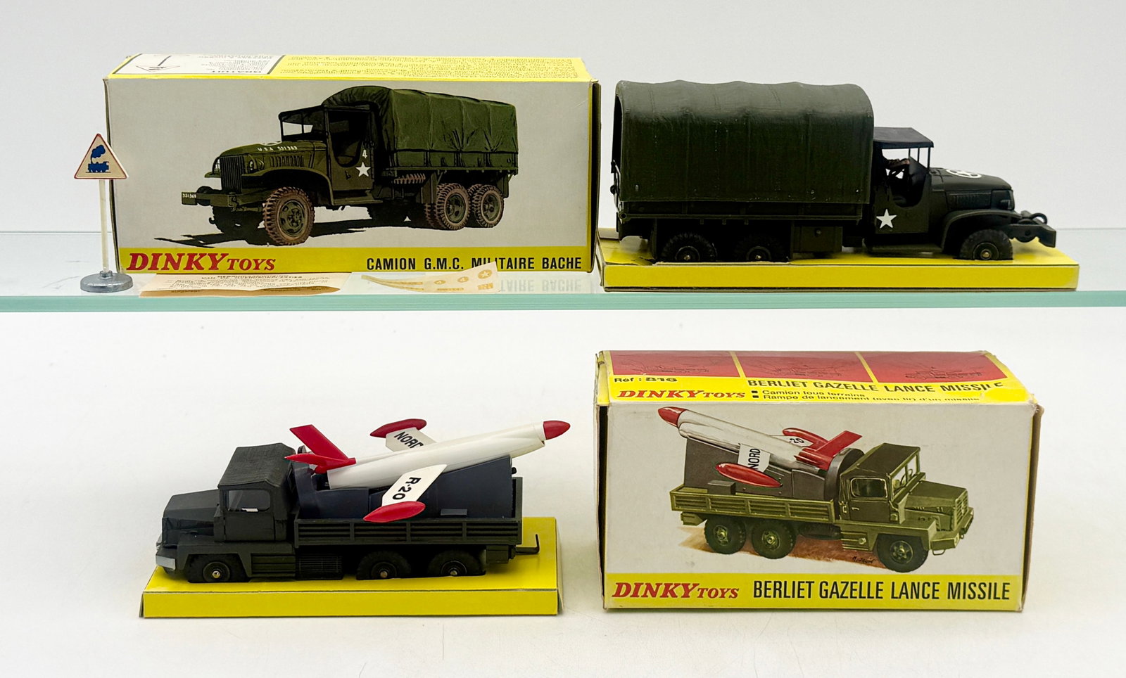 Two French Dinky Toys Military Vehicles in Original Boxes: This lot features two French Dinky Toys die-cast military vehicles comprising a No. 809 G.M.C. Truck and a No. 816 Berliet Gazelle Missile Launcher. Both models are finished in olive drab and retain t