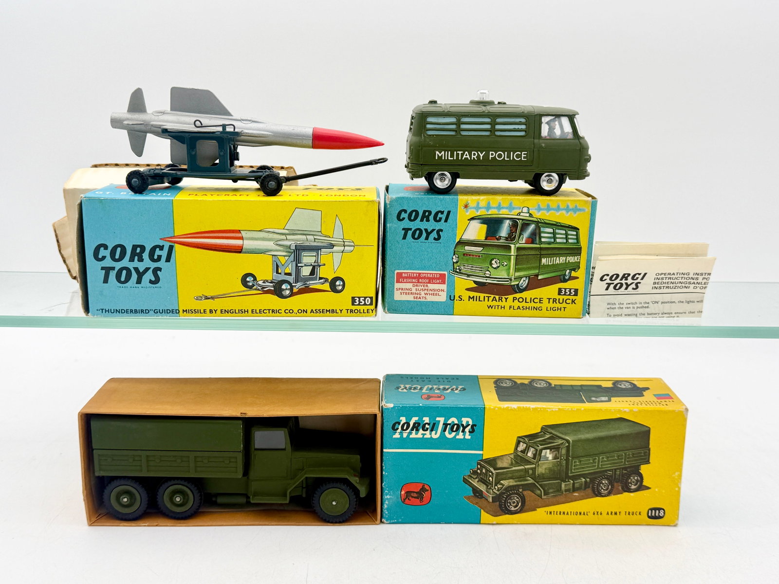 A Collection of Corgi Toys Vintage Die-Cast Military Vehicles: Corgi Toys and Corgi Major Toys military vehicle collection including model numbers 350, 355, and 1118 with original illustrated boxes. The die-cast metal pieces consist of a Thunderbird guided missil