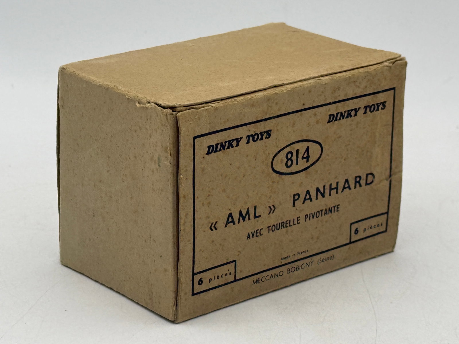 6 French Dinky 814 AML Panhard Armored Cars in Trade Box: Manufactured by Meccano Bobigny, this set of model armored cars is constructed of die-cast metal with an olive drab finish and pivoting turrets. Each vehicle is housed in its original yellow card box 