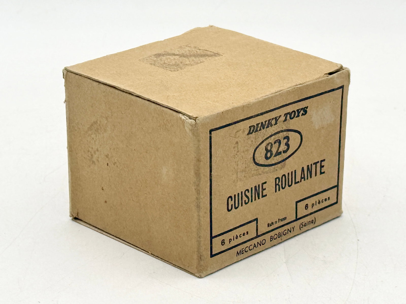 2 French Dinky Toys 823 Cuisine Roulante with Trade box: A collection of French Dinky Toys No. 823 Cuisine Roulante die-cast military models manufactured by Meccano Bobigny. The olive drab field kitchen trailers feature integral chimney stacks and spare tir