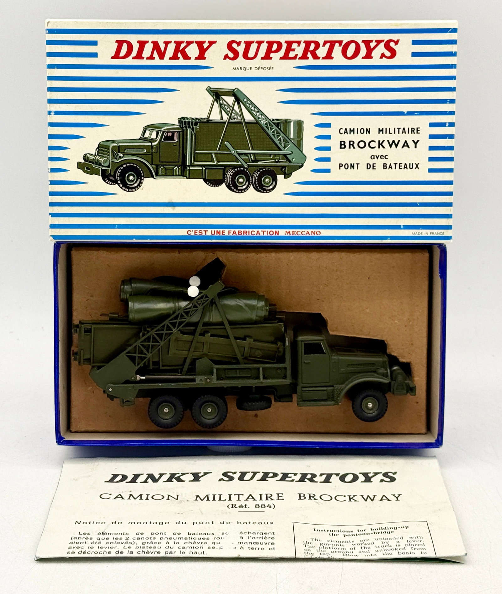 French Meccano Dinky Supertoys Brockway Military Bridge Truck, Ref 884: A French Meccano Dinky Supertoys Ref. 884 Brockway military bridge-laying truck constructed of die-cast metal with an olive drab finish. The model features a working rear crane assembly that carries m