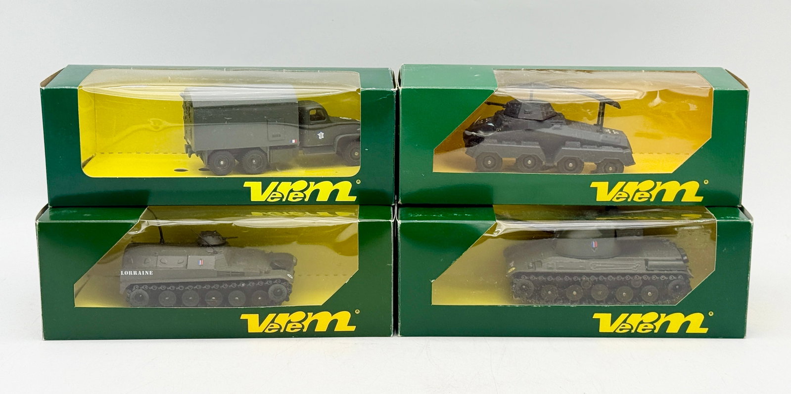 A Collection of Verem Die-Cast Military Vehicles in Original Boxes: A collection of Verem die-cast and plastic military vehicles from the Les Blindés and La Logistique series. The group includes various armored and logistical models, such as an AMX 13 VTT and a