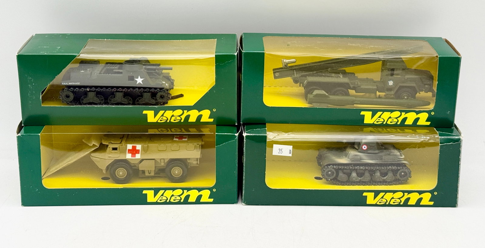 A Collection of Verem Les Blind?©s Die-Cast Military Vehicles: This collection of Verem die-cast military vehicles from the Les Blindés La Logistique series features various armored models including the M7 B1 Priest and Renault R35. Each piece is construct