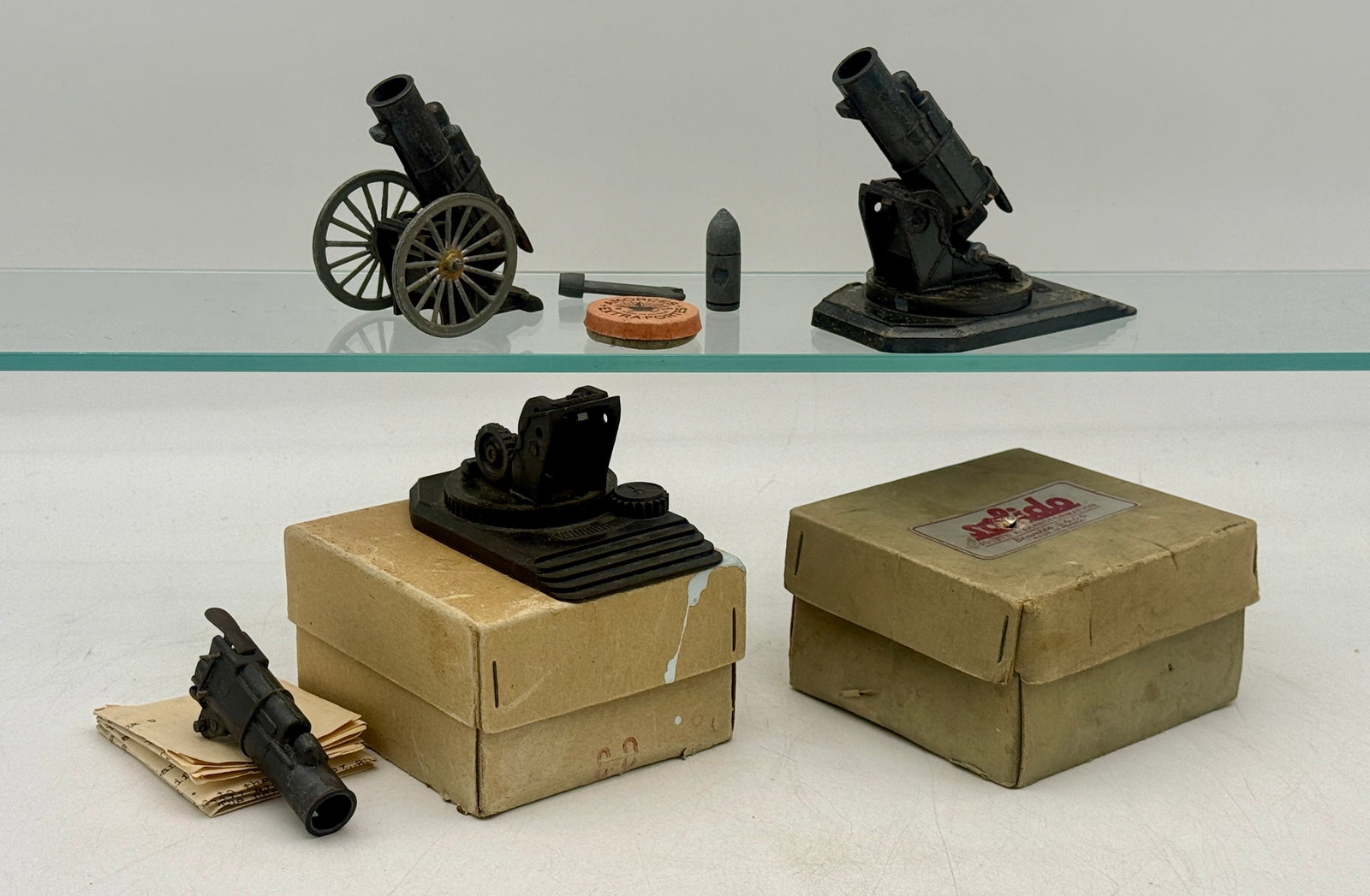 A Collection of Vintage Solido French Die-Cast Model Mortars: This collection features Solido die-cast metal model mortars and interchangeable mounting components of French manufacture. The set includes multiple mortar barrels, wheeled and stationary swivel base