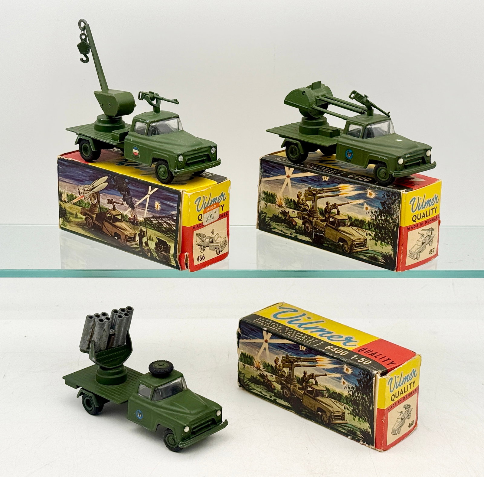 A Trio of Vilmer Die-Cast Chevrolet 6400 Military Trucks: This trio of Vilmer die-cast military vehicles features Chevrolet 6400 cabs in 1:50 scale and was manufactured in Denmark. Each vehicle is finished in olive green paint and equipped with unique attach