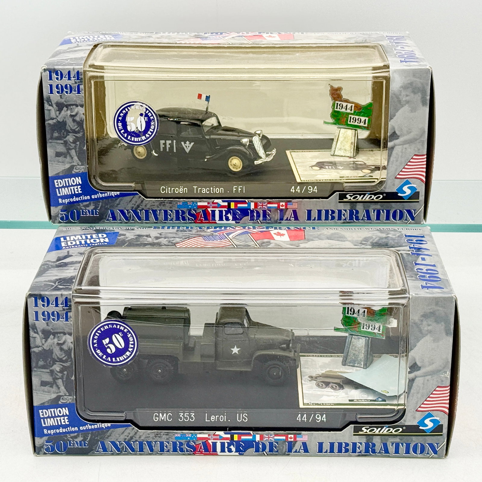 Two Solido 50th Anniversary Liberation of France Model Vehicles: Two Solido die-cast model vehicles produced for the 50th anniversary of the Liberation of France. The collection includes a black Citroën Traction FFI and an olive drab GMC 353 Leroi US military 