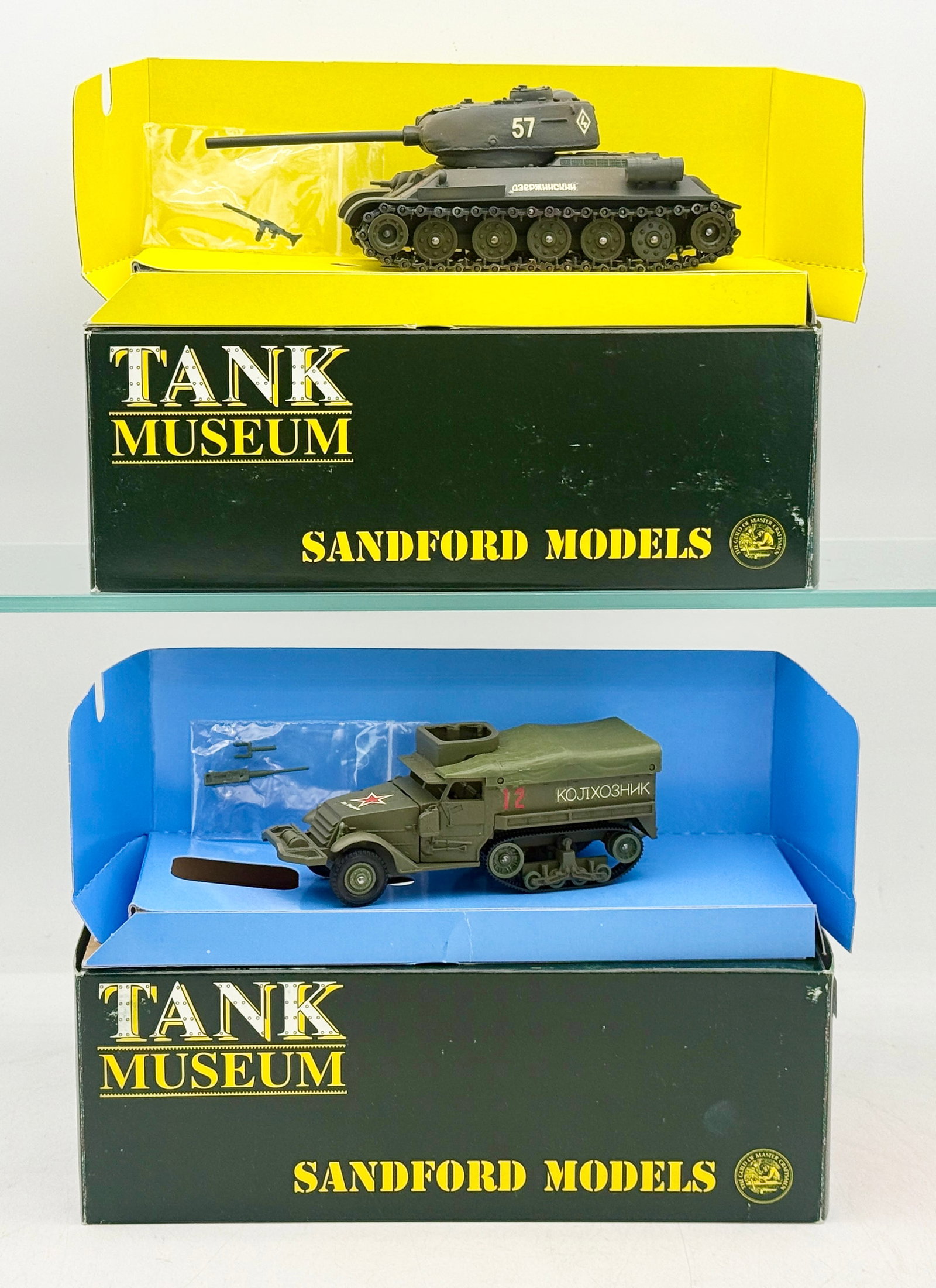 Two Sandford Models Tank Museum Boxed Military Vehicle Models: Two military vehicle models by Sandford Models from the Tank Museum series, comprising a T-34 tank and an M3 half-track. The models are finished in olive green with hand-applied Soviet decals includin