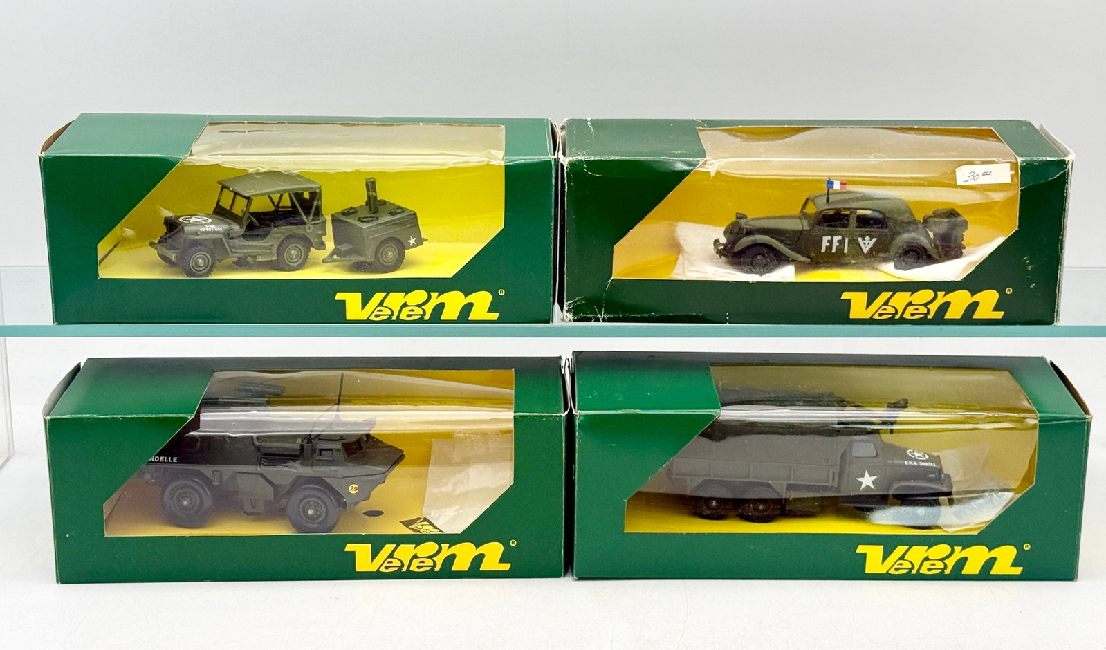 A Collection of Boxed Verem Diecast Military Vehicle Models: A collection of diecast military vehicle models produced by Verem as part of the Les Blindés La Logistique series. The group includes a VAB 4x4 missile launcher, a GMC turret truck, a Citroen 1