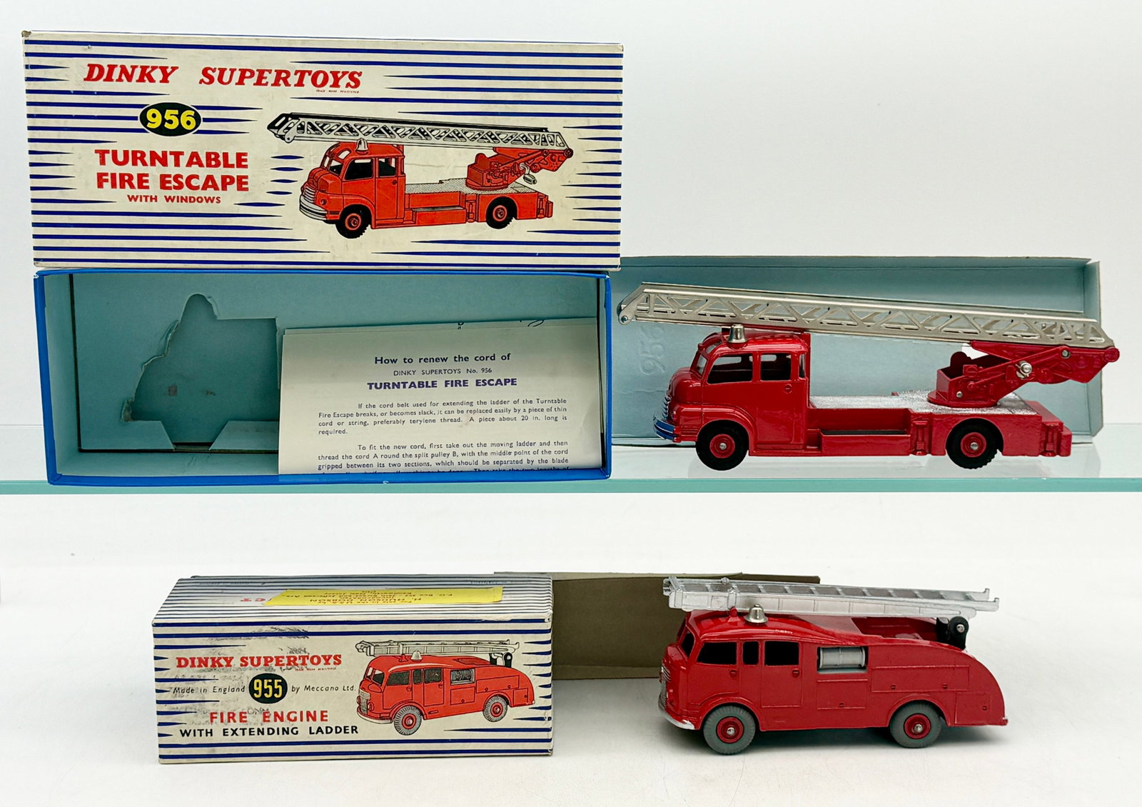 Two Vintage Dinky Supertoys No. 955 and 956 Fire Engines: Dinky Supertoys No. 956 Turntable Fire Escape and No. 955 Fire Engine with Extending Ladder, produced in England by Meccano Ltd. These die-cast vehicles feature red enameled finishes with silver-toned