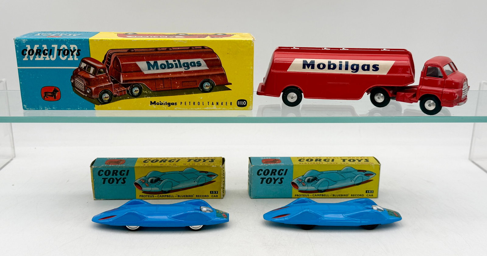 A Collection of Vintage Corgi Die-Cast Model Vehicles and Boxes: A collection of Corgi die-cast models including a Bedford S Type Mobilgas tanker and Proteus-Campbell Bluebird record cars. These models feature original factory paint finishes and are presented with 