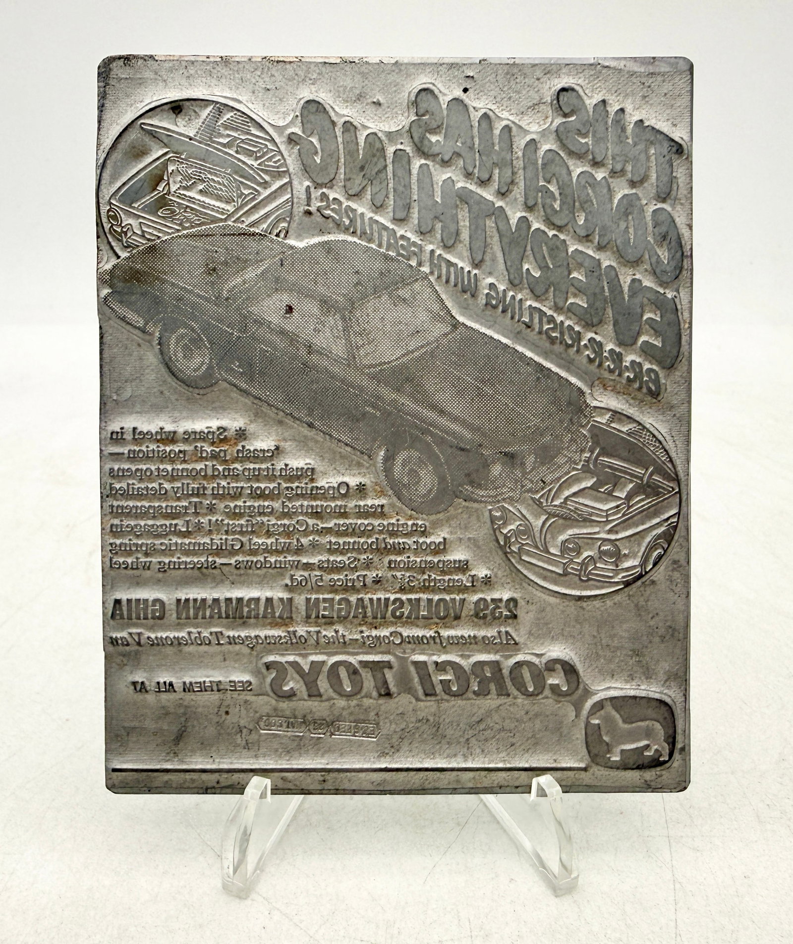 Vintage Corgi Toys Volkswagen Karmann Ghia Advertisement Printing Plate: This Corgi Toys advertising printing plate features the No. 239 Volkswagen Karmann Ghia with reversed text and graphics. It is constructed of a metal alloy block mounted on a ribbed base, illustrating