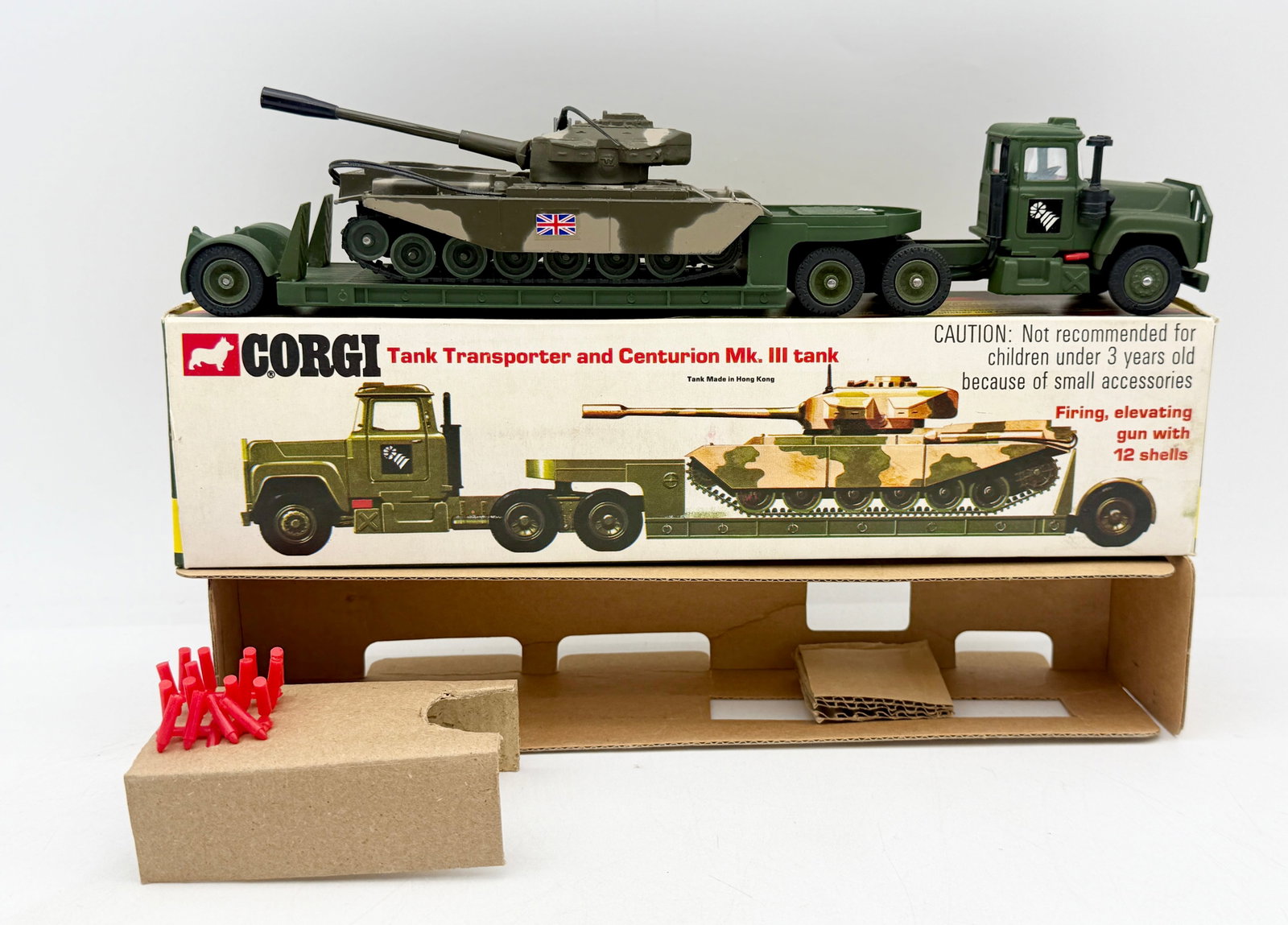 Corgi Gift Set 10 Mack Transporter and Centurion Tank: This Corgi Gift Set 10 comprises a die-cast Mack tractor unit in olive green, a matching low-loader trailer, and a camouflaged Centurion Mk. III tank. The tank is equipped with a firing gun mechanism 