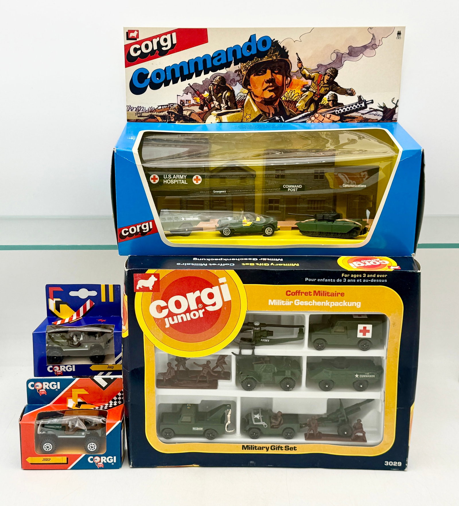 An Assortment of Vintage Corgi Die-Cast Military Toy Vehicles: Corgi and Corgi Junior die-cast military toy sets comprise this assortment, featuring the Commando No. 3118 and Military Gift Set No. 3029. Each set is housed in its original window-display retail box