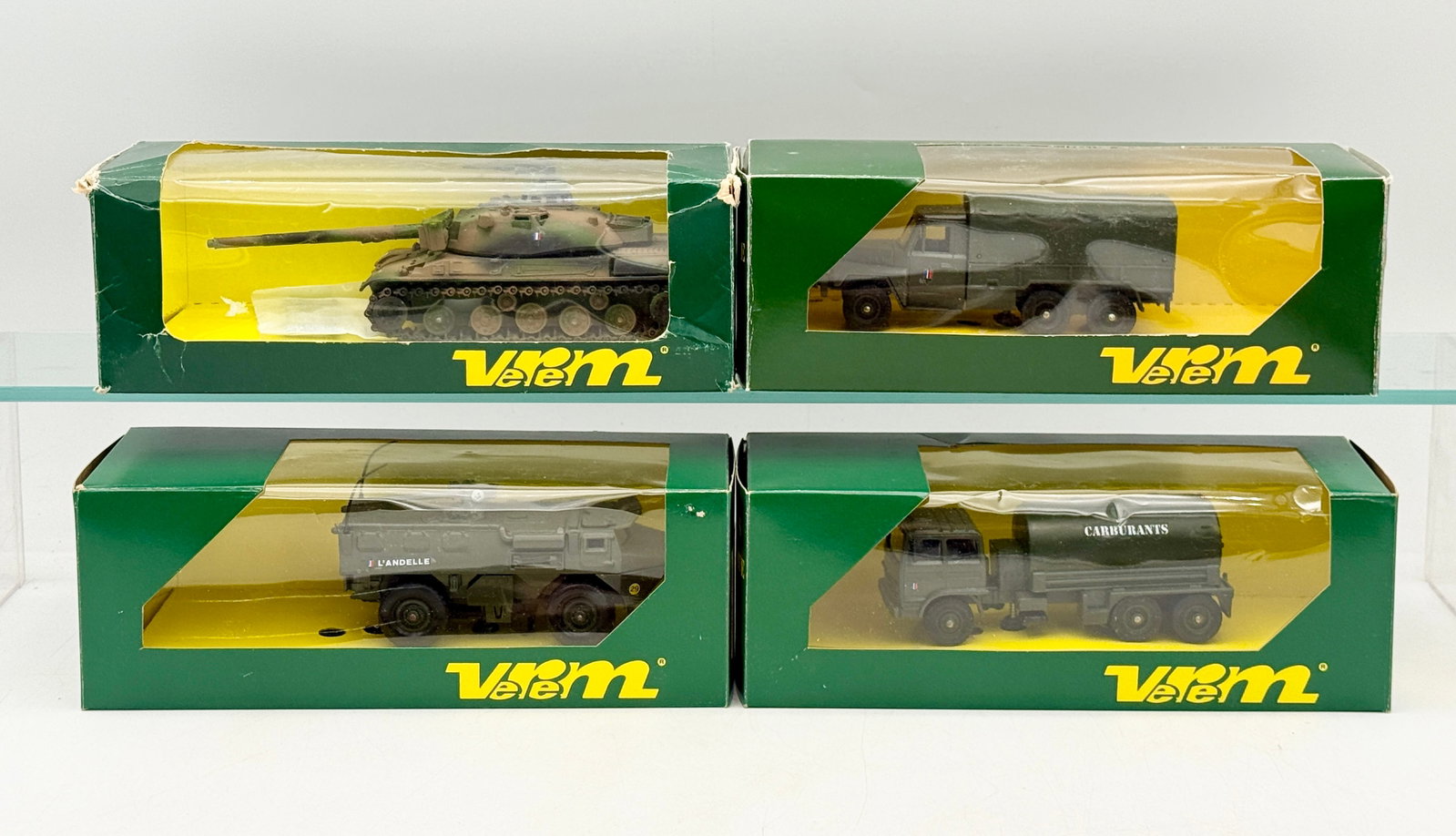 A Group of Boxed Verem Die-Cast French Military Vehicles: A group of die-cast French military vehicle models manufactured by Verem as part of the Les Blindes La Logistique series. The assortment includes an AMX 30 B2 tank, an ACMAT 6x6 V.L.R.A. truck, a VAB 