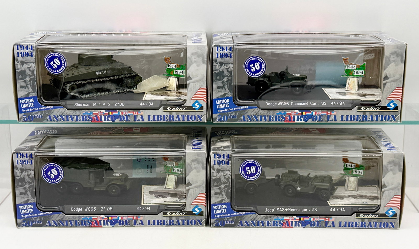 A Collection of Solido 50th Anniversary Liberation Die-Cast Vehicles: A collection of Solido die-cast military vehicles produced to commemorate the 50th Anniversary of the Liberation (1944-1994). The set includes a Sherman M4A3 tank, a Dodge WC56 Command Car, a Dodge WC