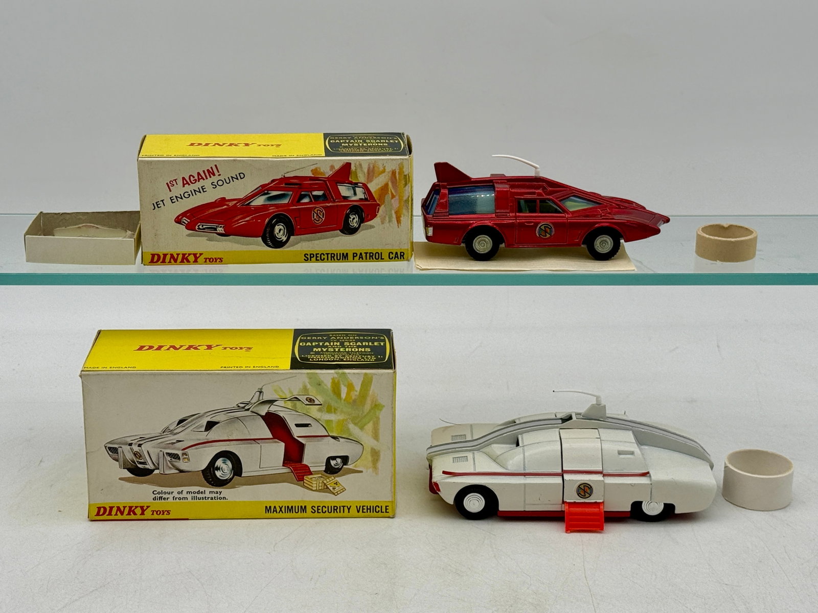 Two Dinky Toys Captain Scarlet Die-Cast Vehicles with Boxes: Dinky Toys produced these die-cast metal vehicles inspired by the Gerry Anderson series Captain Scarlet and the Mysterons. The collection consists of a metallic red No. 103 Spectrum Patrol Car and a w