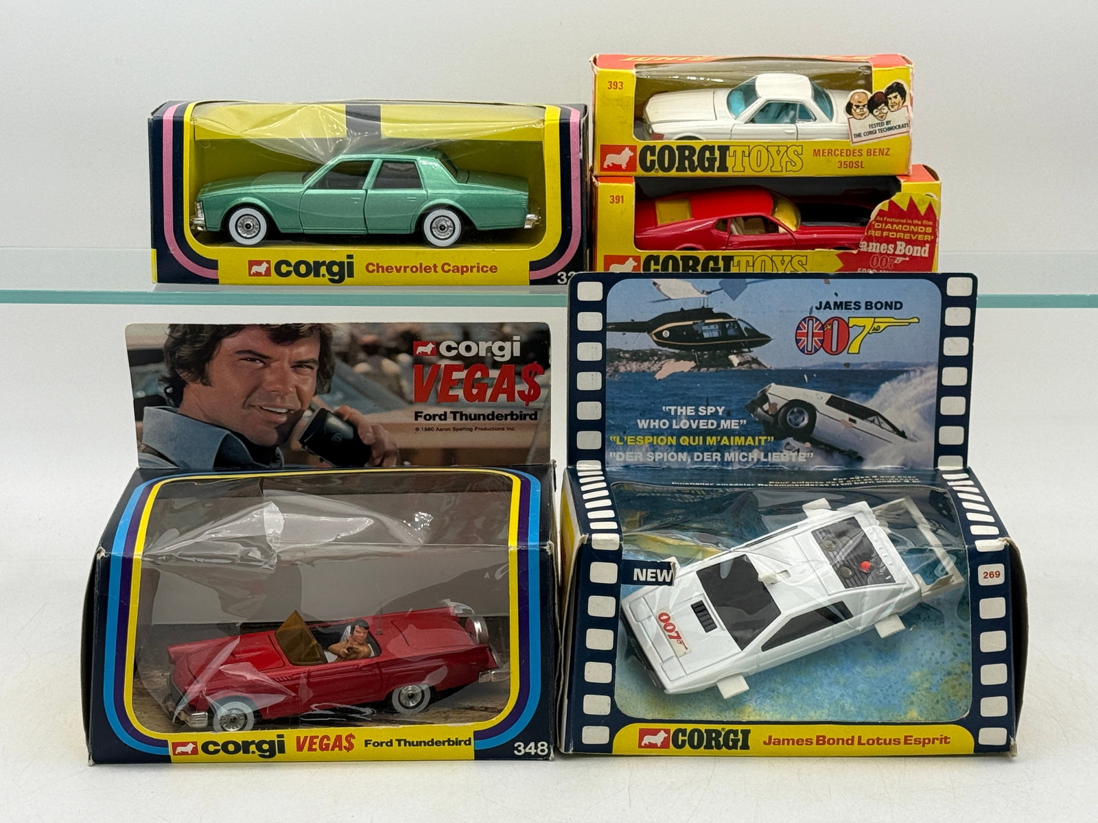 A Group of Vintage Corgi Die-Cast Character Model Vehicles: A group of die-cast metal vehicles manufactured by Corgi and The Mettoy Co. Ltd. dating from the late 1970s to early 1980s. The collection includes character-themed models such as the James Bond 007 L