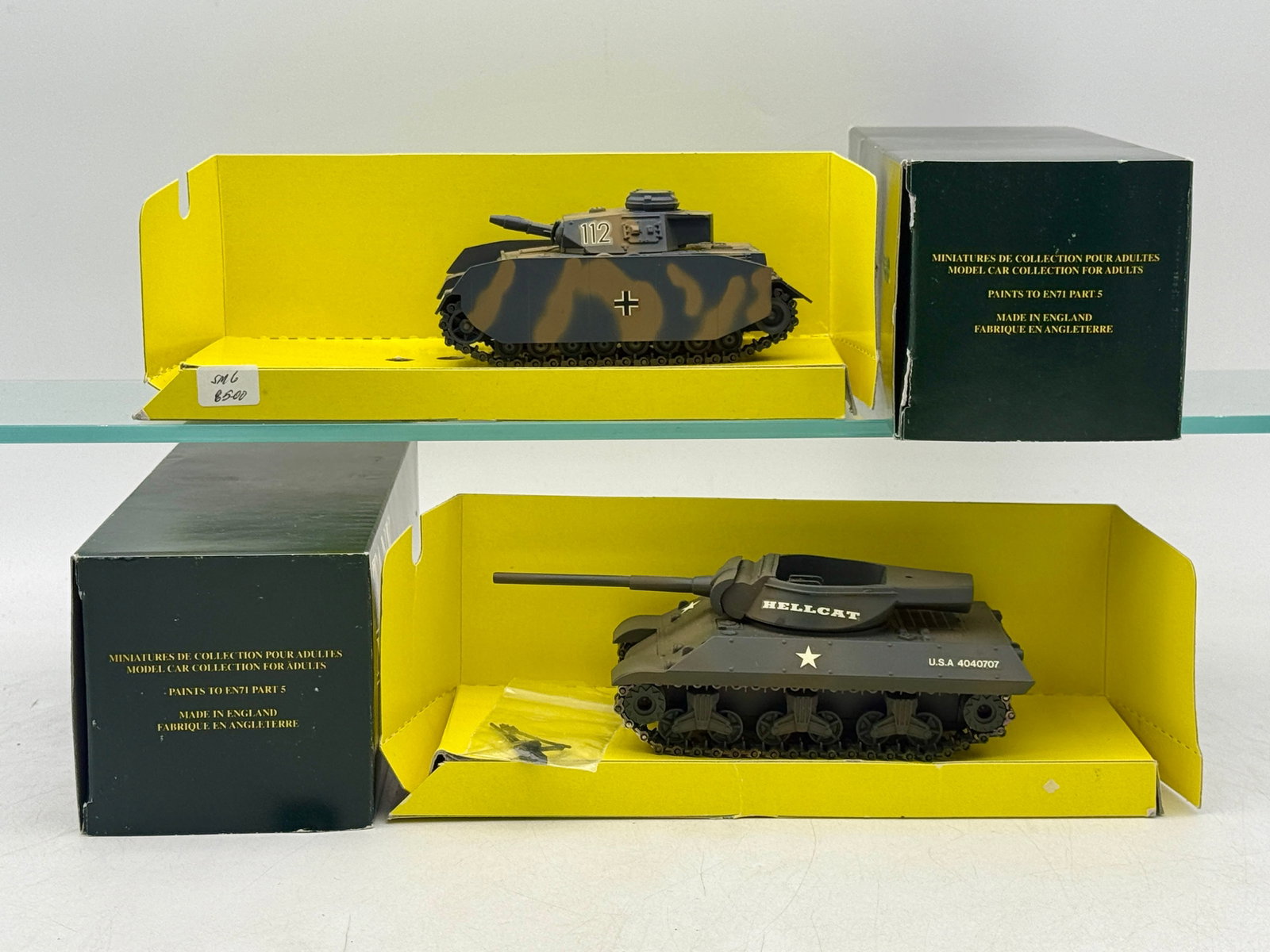 A Pair of Sandford Models Tank Museum Miniature Scale Tanks: A pair of Sandford Models diecast miniature tanks produced for the Tank Museum in England. The lot comprises a German Panzer IV variant with camouflage and side skirts, alongside a US M18 Hellcat tank