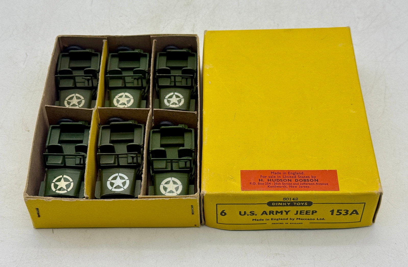 Dinky Toys 153A U.S. Army Jeep Six-Piece Die-Cast Set: A Dinky Toys 153A U.S. Army Jeep set comprising die-cast metal vehicles finished in olive drab with white star decals. Each model features black plastic wheels, a steering wheel, and a rear-mounted sp
