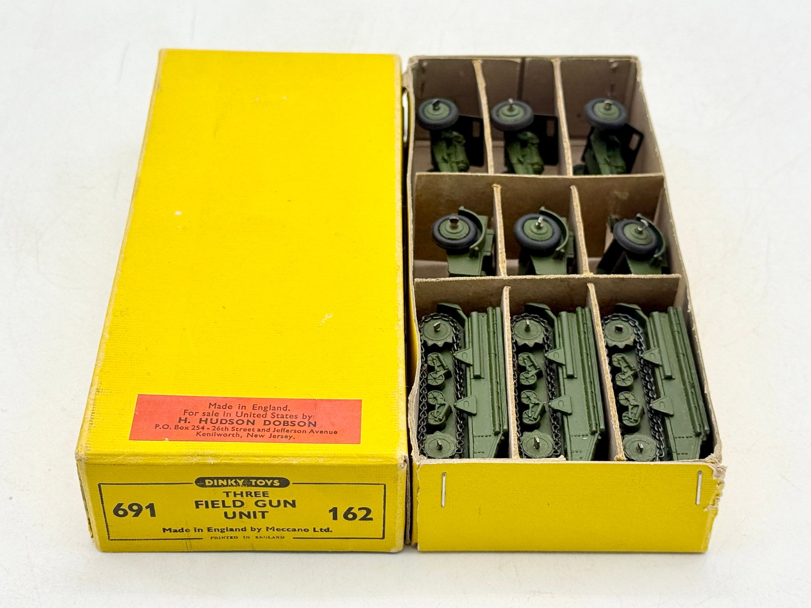 Dinky Toys 691 Three Field Gun Unit in Original Box: Dinky Toys Three Field Gun Unit, model 691, manufactured in England by Meccano Ltd. This die-cast metal collection includes tracked artillery tractors, ammunition limbers, and field guns finished in o