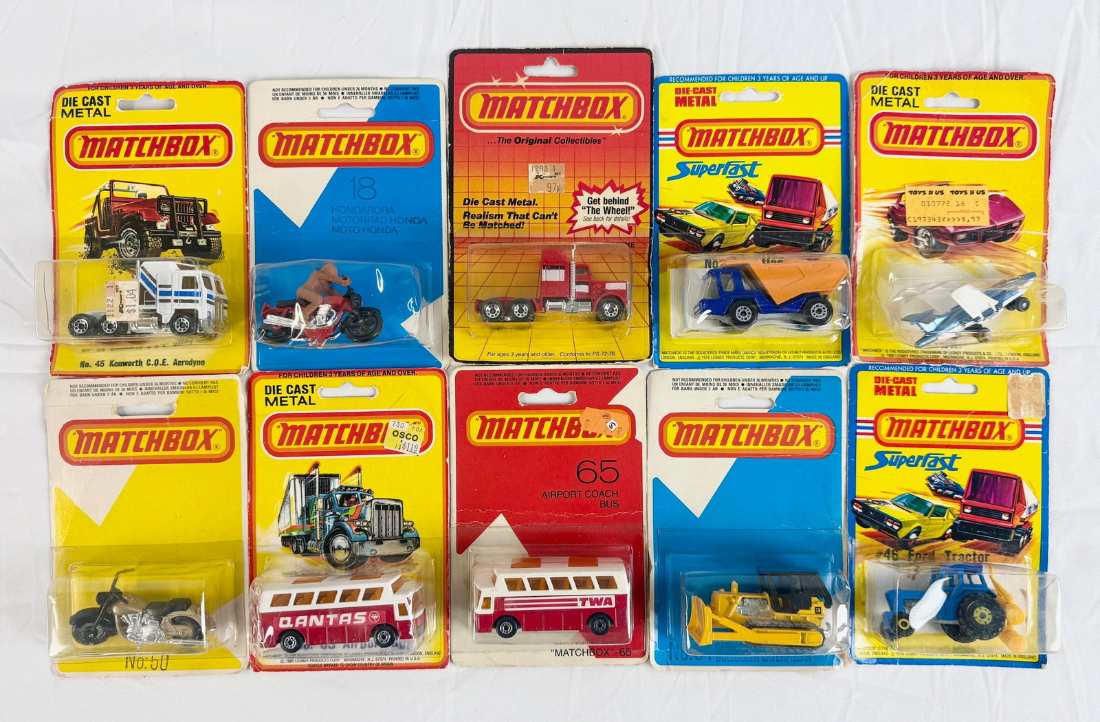 An Assortment of Vintage Matchbox Superfast Die-Cast Vehicles: Matchbox die-cast metal and plastic vehicles in original blister pack packaging produced during the late 1970s and early 1980s. The collection comprises various utility and transport models including 