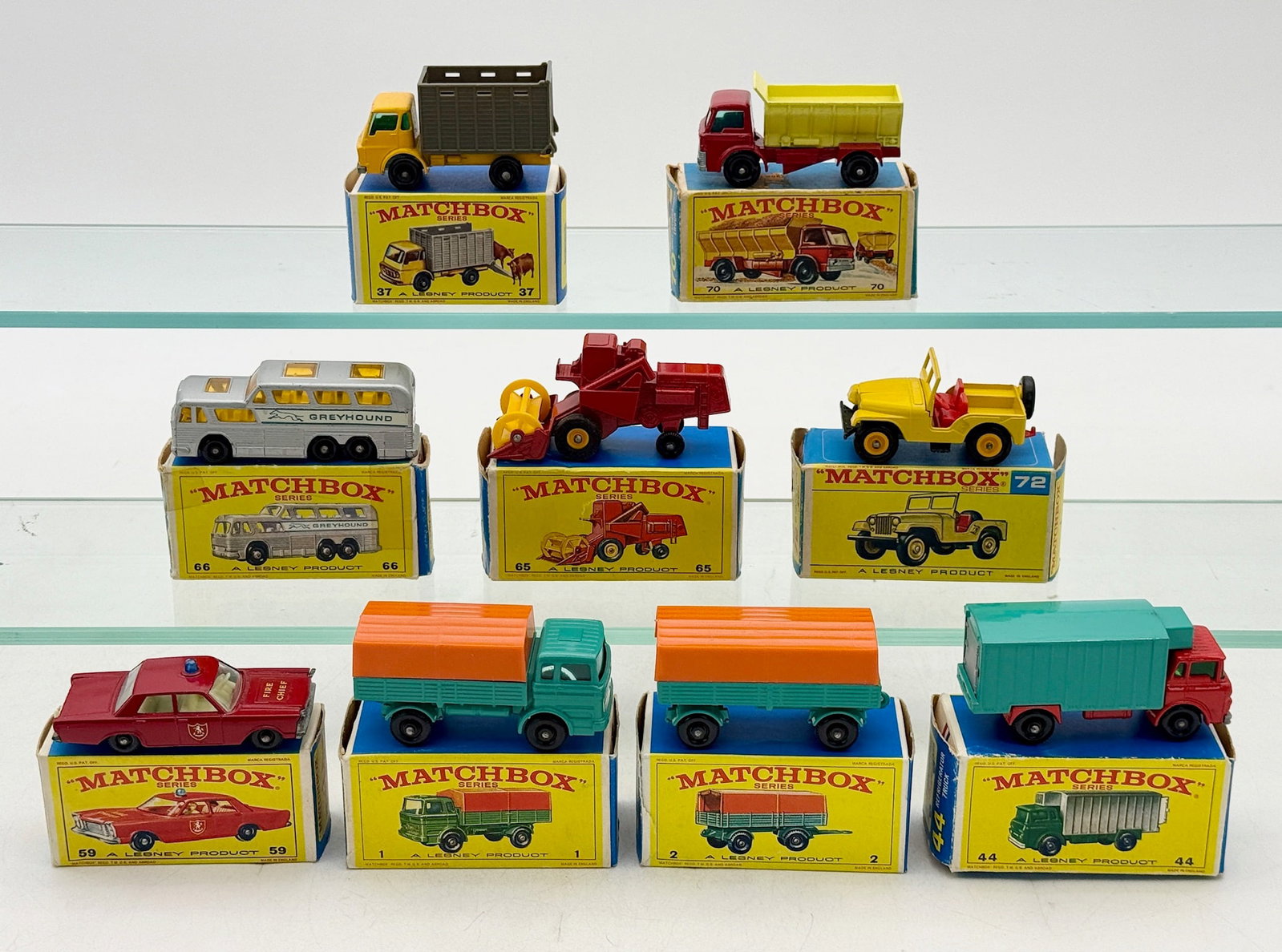 A Group of Vintage Lesney Matchbox Series Die-Cast Vehicles: A collection of vintage Matchbox Series die-cast toy vehicles manufactured by Lesney Products in England. Each miniature vehicle is constructed of die-cast metal with plastic components and is accompa