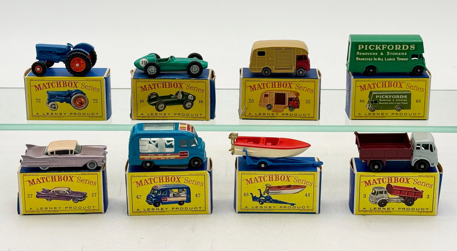 A Collection of of Vintage Lesney Matchbox Series Die-Cast Vehicles: This collection features various Lesney Matchbox Series die-cast miniatures, each accompanied by its original yellow and blue pictorial box. The group includes 3B3, 48B6, 47B2, 27C4, 72A6, 35A2, 19C4,