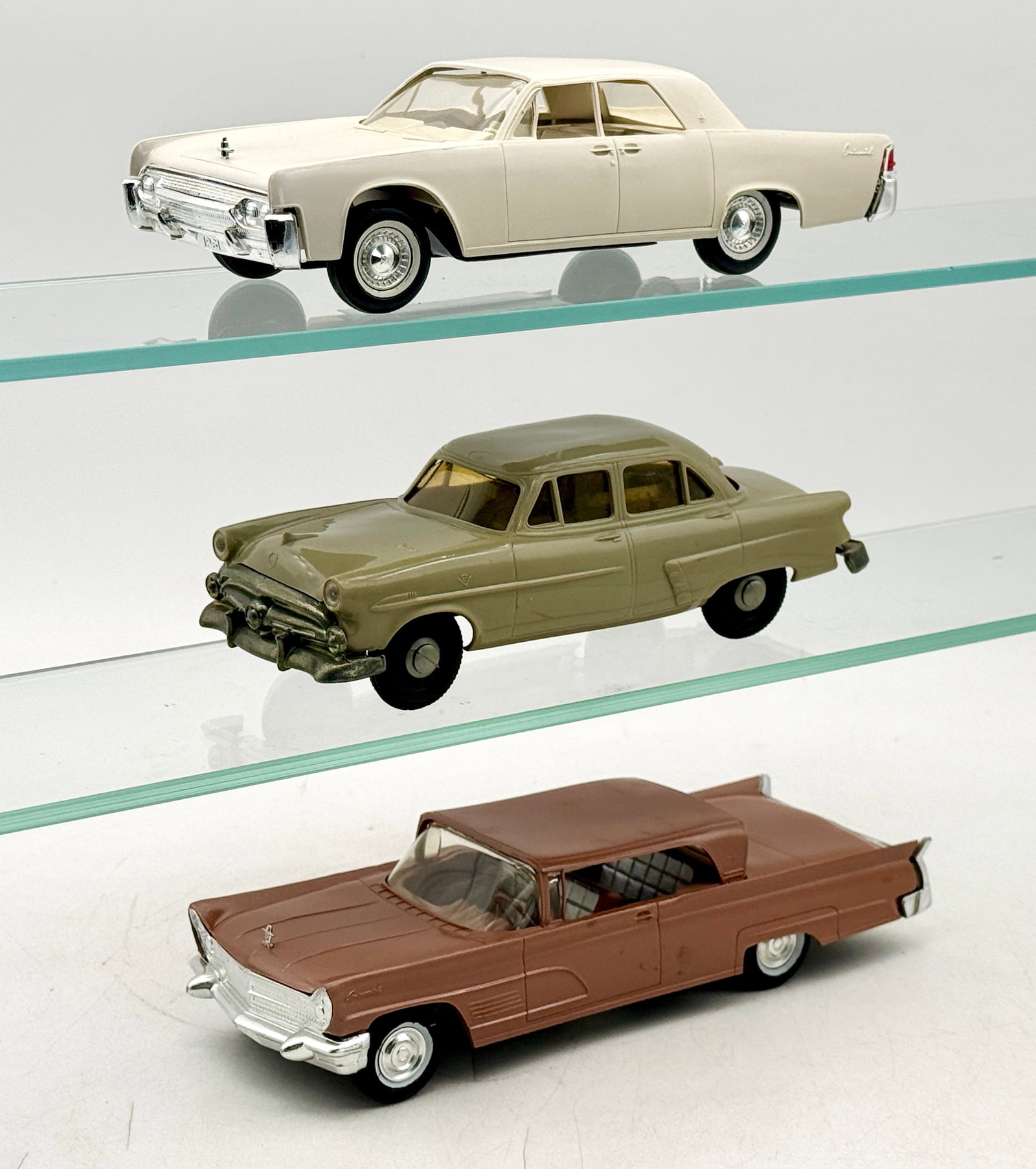 3 AMT Vintage American Sedan Dealership Promotional Models: Three vintage dealership promotional model cars representing mid-century American luxury sedans, produced by AMT. The lot includes an AMT 1961 Lincoln Continental in white Friction Working, a 1960 Lin