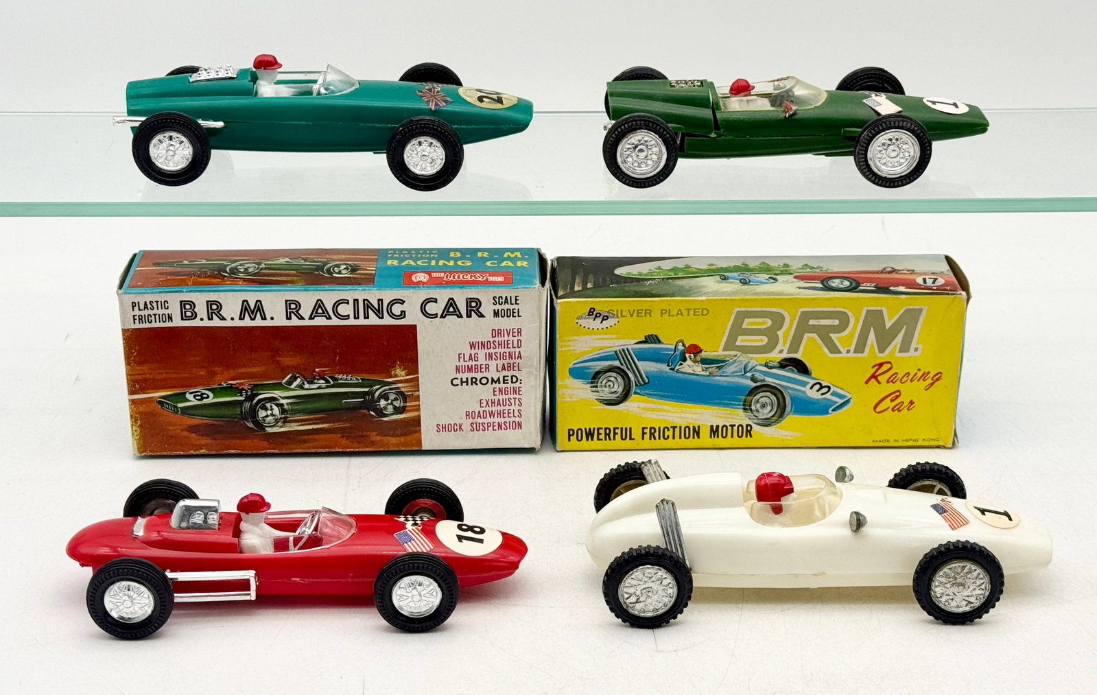 4 BRM Formula Racing Cars: This collection includes plastic friction-powered Formula 1 racing cars manufactured by Lucky Toys and BRM in Hong Kong. Each model features a driver figure, clear windshield, and chromed engine detai