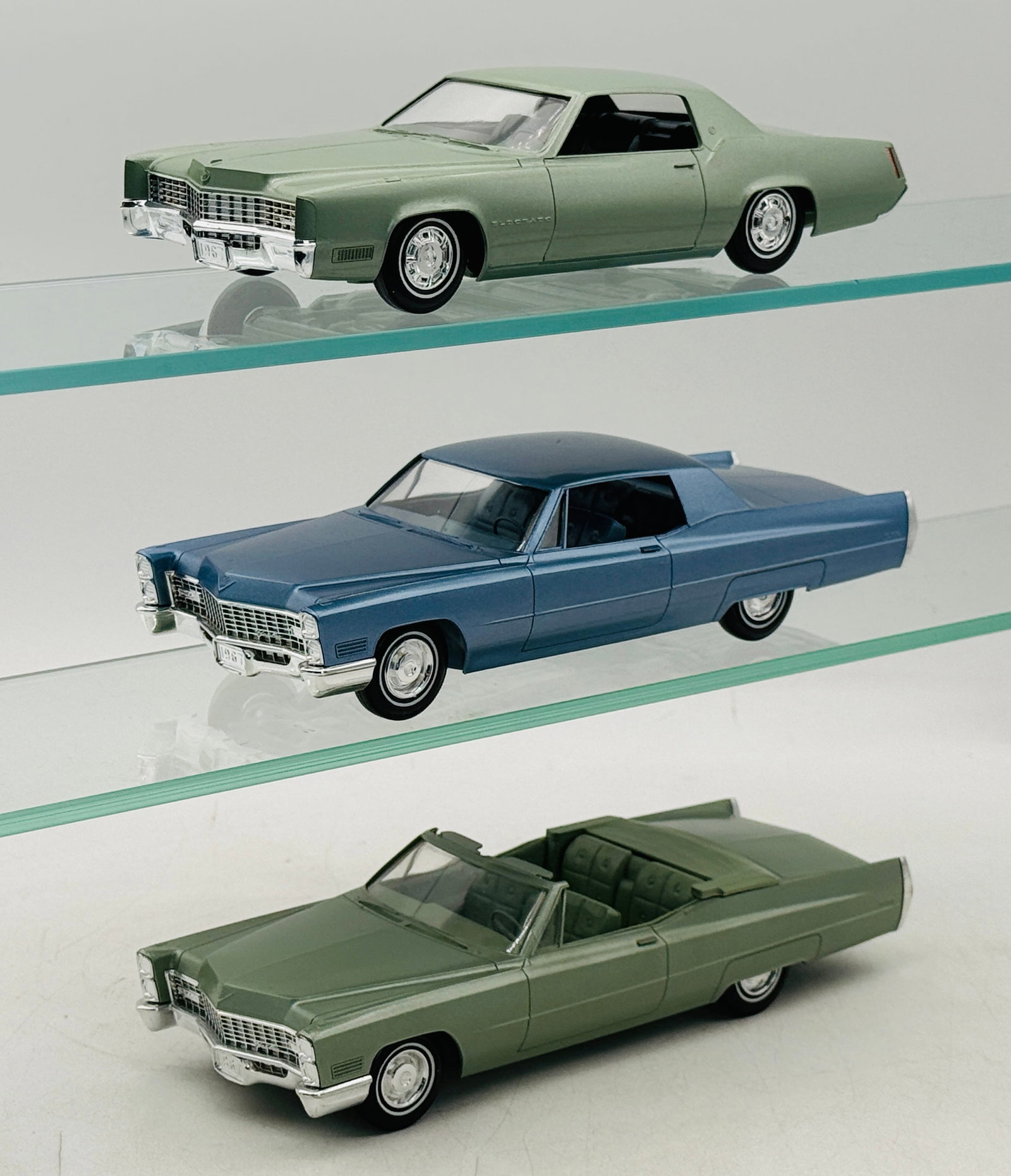 3 Jo-Han 1967 Cadillac Promotional Model Cars: Three Jo-Han 1/25 scale dealership promotional models of 1967 Cadillac automobiles. These models are constructed of molded plastic with metallic finishes and chrome-plated plastic bumpers. The group f
