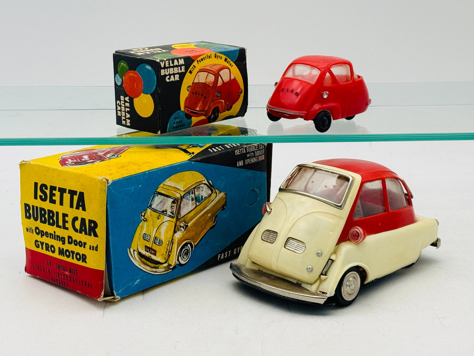 2 Lincoln International Friction Powered Bubble Car Toy Models: Lincoln International produced these two friction-powered microcar models, comprising an Isetta and a Velam bubble car. Both examples feature molded bodies with integrated gyro motors and are presente