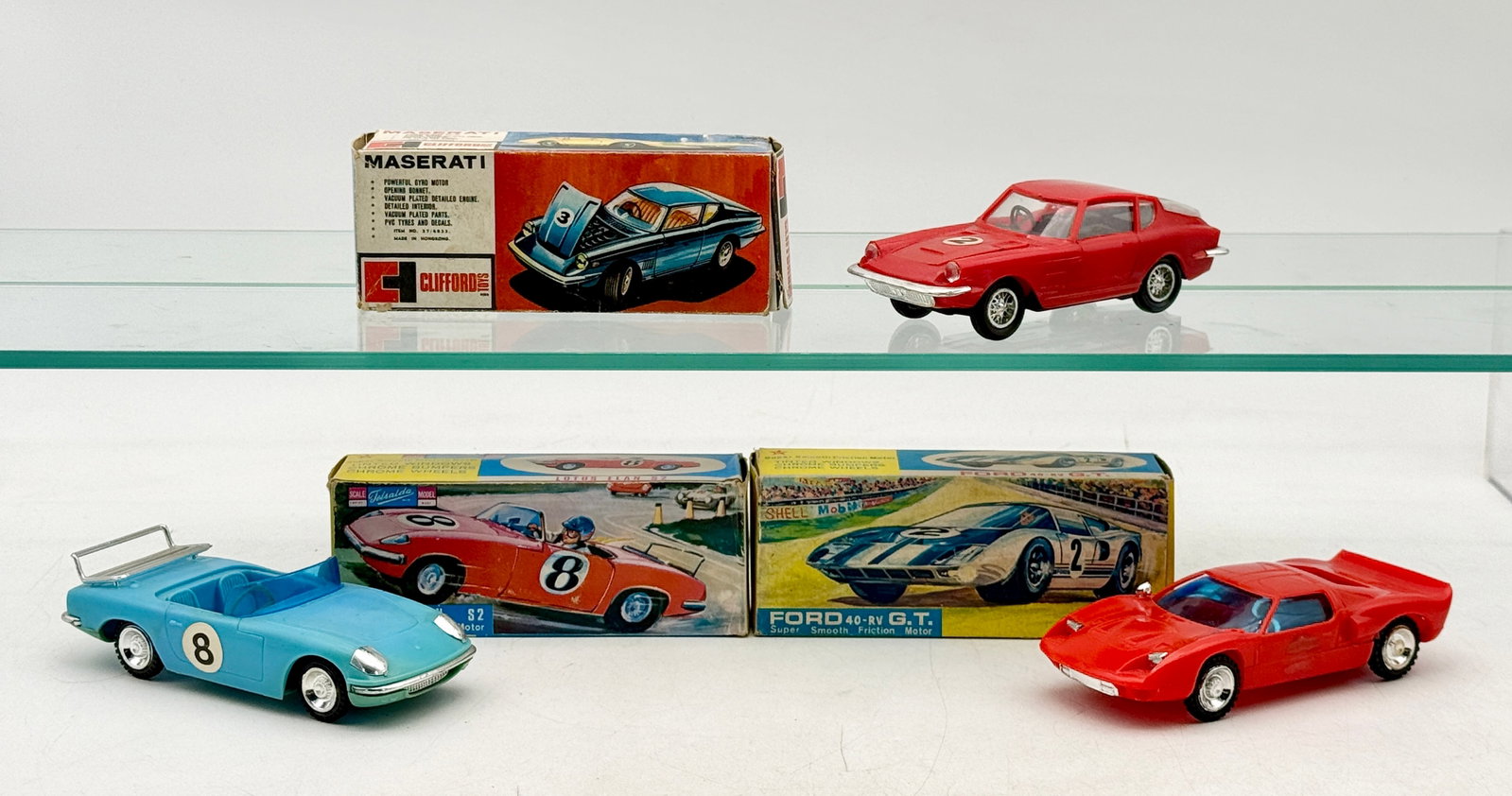 3 Vintage Hong Kong Plastic Friction Sports Cars w/Original Boxes: Tat, Clifford Toys and Telsalda manufactured this group of three friction-powered plastic toy cars in Hong Kong during the 1960s. The lot includes a red Clifford 1967 Maserati with an opening hood, a 