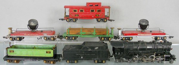 AMERICAN FLYER TRAIN SET: O ga, 435 loco, 433A tender, minor die cast warp, 2 steps broken, 409 dump, 2 couplers incom, 406 log car, 2 #415 floodlight cars, 411 caboose, C4-5.