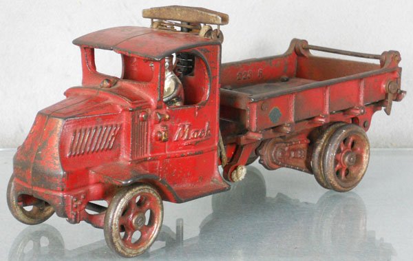 ARCADE MACK DUMP TRUCK: painted cast iron, 12" long, driver replaced, paint missing in bed, playworn, C4.