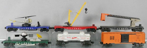 6 LIONEL FREIGHT CARS: O ga, 3419 helicopter car, 6670 boom crane, 6512 cherrypicker car, crack on 1 side of astronaut cage, 3519 satellite car, satellite broken, 6463 rocket fuel tank car, 6464-725 New Haven box car, C5-6.
