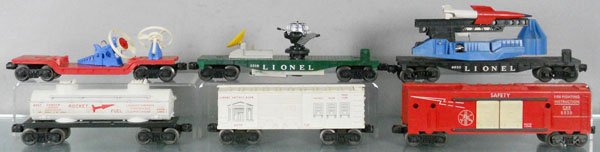 6 LIONEL FREIGHT CARS: O ga, 3309 missile launching car, 3519 satellite launcher, satellite broken, 6630 rocket launcher, rocket broken, 6463 rocket fuel tank, 6050 bank box car, 6530 fire safety car, C5-6.